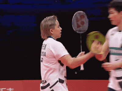 A Badminton Player Wearing A Shirt That Says ' Green Vision ' On The Back GIF