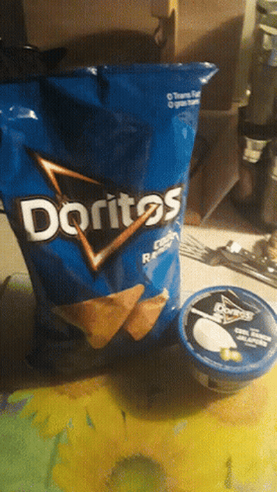 A Bag Of Doritos Lays On A Table Next To A Container Of Sour Cream GIF