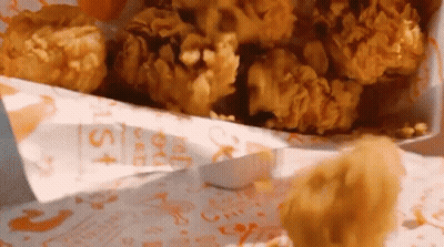 A Bag Of Fried Chicken With A Sticker That Says ' Chicken Nuggets ' On It GIF