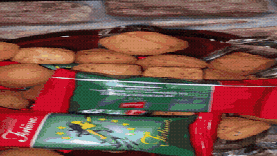 A Bag Of Tortina Cookies Sits Next To A Bowl Of Cookies GIF