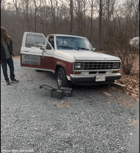 A Baker Truck Is Parked In A Gravel Area GIF