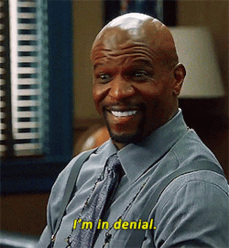 A Bald Man In A Blue Shirt And Tie Is Smiling And Says I 'M In Denial GIF
