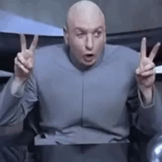 A Bald Man In A Blue Shirt Is Giving A Peace Sign . GIF