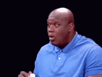 A Bald Man In A Blue Shirt Is Holding A Bottle Of Milk In His Hand . GIF