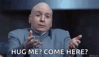A Bald Man In A Blue Suit Is Giving A Hug And Asking To Come Here . GIF
