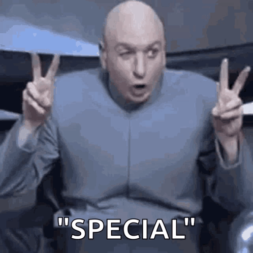 A Bald Man In A Blue Suit Is Giving A Peace Sign And Says `` Special '' . GIF