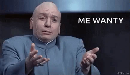 A Bald Man In A Blue Suit Is Making A Funny Face And Pointing At The Camera With The Words `` Me Wanty '' . GIF