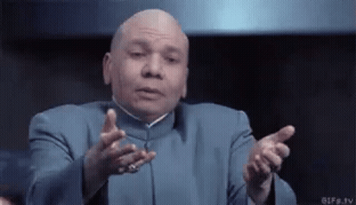 A Bald Man In A Blue Suit Is Making A Funny Face With His Hands Outstretched GIF