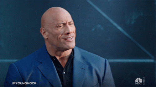 A Bald Man In A Blue Suit With The Hashtag Youngrock GIF