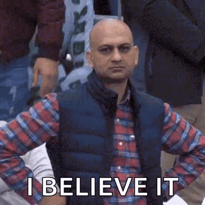 A Bald Man In A Plaid Shirt And Vest Is Holding His Hands On His Hips And Says `` I Believe It '' GIF