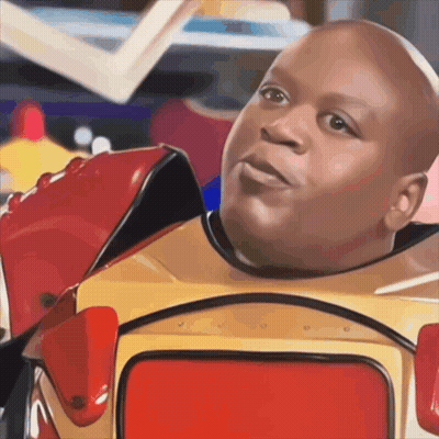 A Bald Man In A Red And Yellow Robot Costume Looks At The Camera GIF