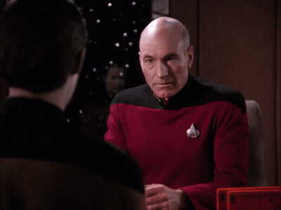A Bald Man In A Red Shirt Wipes His Face With His Hands GIF