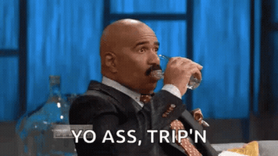 A Bald Man In A Suit And Tie Is Drinking Water From A Glass . GIF