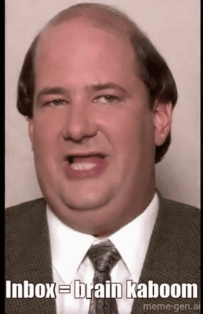 A Bald Man In A Suit And Tie Is Making A Funny Face And Saying `` Inbox = Brain Kaboom '' . GIF