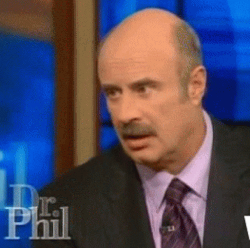 A Bald Man In A Suit And Tie Is On A Dr Phil Show GIF