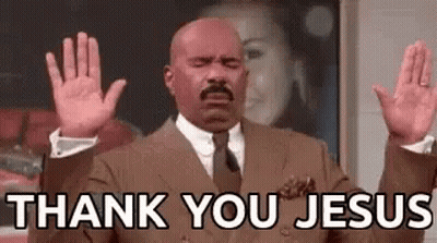 A Bald Man In A Suit And Tie Is Raising His Hands In The Air And Saying `` Thank You Jesus '' . GIF