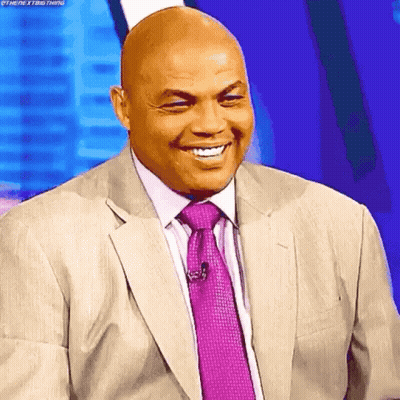 A Bald Man In A Suit And Tie Is Smiling With His Eyes Closed GIF