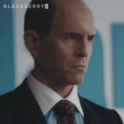 A Bald Man In A Suit And Tie With The Word Blackberry On The Bottom GIF