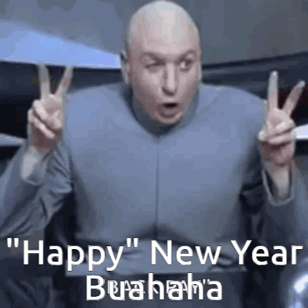 A Bald Man In A Suit Is Giving A Peace Sign And Saying Happy New Year . GIF