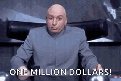 A Bald Man In A Suit Is Sitting In A Chair And Holding A Cell Phone . GIF