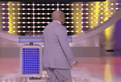 A Bald Man In A Suit Is Standing In Front Of A Blue Lighted Podium GIF