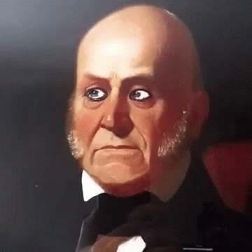A Bald Man In A Tuxedo And Bow Tie Is Looking At The Camera GIF