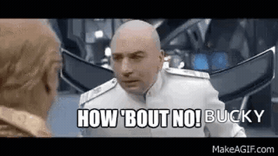 A Bald Man In A White Suit Is Talking To Another Bald Man In A Room . GIF