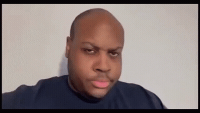 A Bald Man Is Blowing A Pink Bubble With His Mouth Open . GIF
