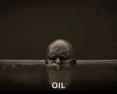 A Bald Man Is Covered In Oil And The Word Oil Is Next To Him GIF