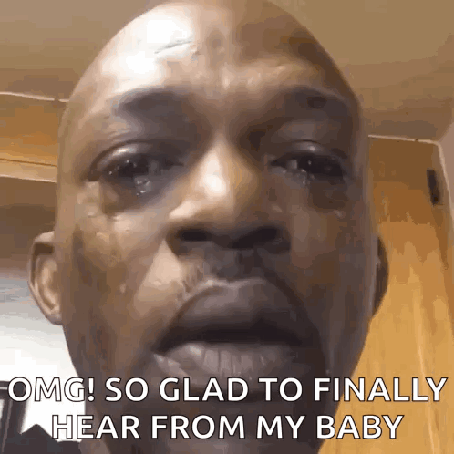 A Bald Man Is Crying And Saying " Omg So Glad To Finally Hear From My Baby " . GIF