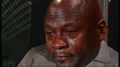 A Bald Man Is Crying With Tears Running Down His Face While Wearing A White Shirt . GIF
