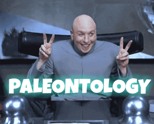 A Bald Man Is Giving A Peace Sign In Front Of A Sign That Says Paleontology GIF