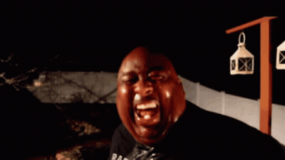 A Bald Man Is Holding A Bottle In His Hand And Looking At The Camera GIF