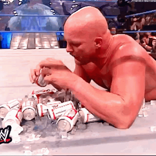 A Bald Man Is Laying On The Floor Eating Budweiser Cans GIF
