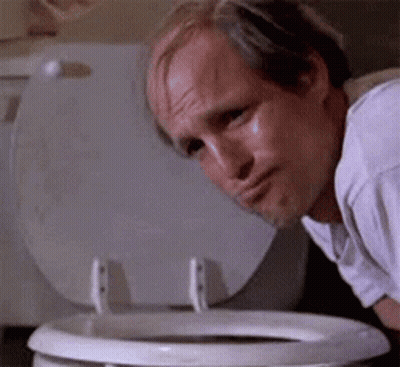 A Bald Man Is Looking Into A Toilet Bowl . GIF