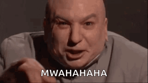 A Bald Man Is Making A Funny Face And Pointing At The Camera While Saying Mwahaha . GIF