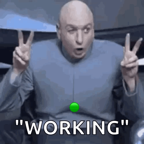 A Bald Man Is Making A Peace Sign With His Hands And Says `` Working '' . GIF