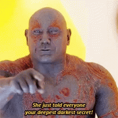 A Bald Man Is Pointing At The Camera And Says `` She Just Told Everyone Your Deepest Darkest Secret ! '' GIF