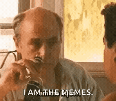 A Bald Man Is Sitting At A Table Drinking A Glass Of Wine . GIF