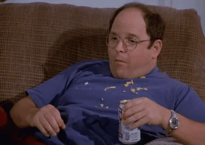 A Bald Man Is Sitting On A Couch Eating Chips And Drinking Bud Light GIF