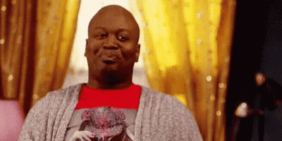 A Bald Man Is Sitting On A Couch In Front Of A Window . GIF