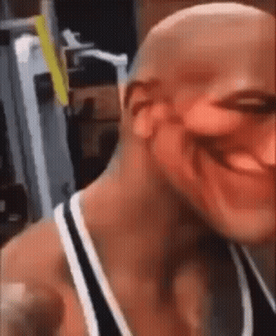 A Bald Man Is Smiling In A Gym . GIF