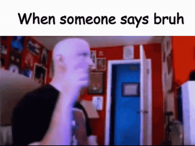 A Bald Man Is Standing In A Room With A Blue Door And A Red Wall . GIF
