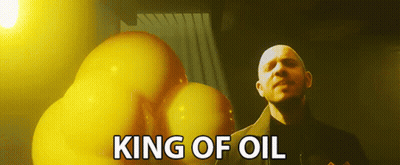 A Bald Man Is Standing In Front Of A Bunch Of Yellow Balloons With The Words King Of Oil Above Him GIF