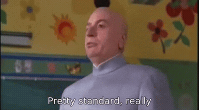 A Bald Man Is Standing In Front Of A Chalkboard In A Classroom And Says `` Pretty Standard , Really '' . GIF