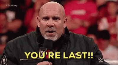 A Bald Man Is Standing In Front Of A Microphone And Says You 'Re Last . GIF