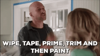 A Bald Man Is Talking To A Woman In A Kitchen And Saying `` Wipe , Tape , Prime , Trim And Then Paint '' GIF
