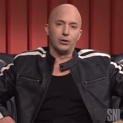 A Bald Man Is Wearing A Black Shirt And A Black Leather Jacket With A Snl Logo On It GIF