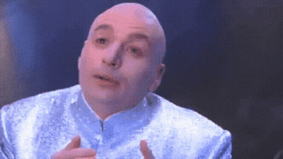 A Bald Man Is Wearing A Blue Jacket And Making A Face GIF