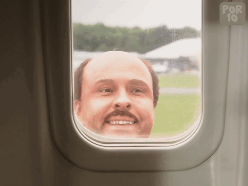 a bald man looks out of an airplane window with a por 10 logo in the background